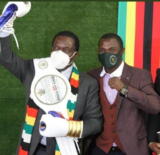 Charles Manyuchi presented with a belt alongside a national dignitary